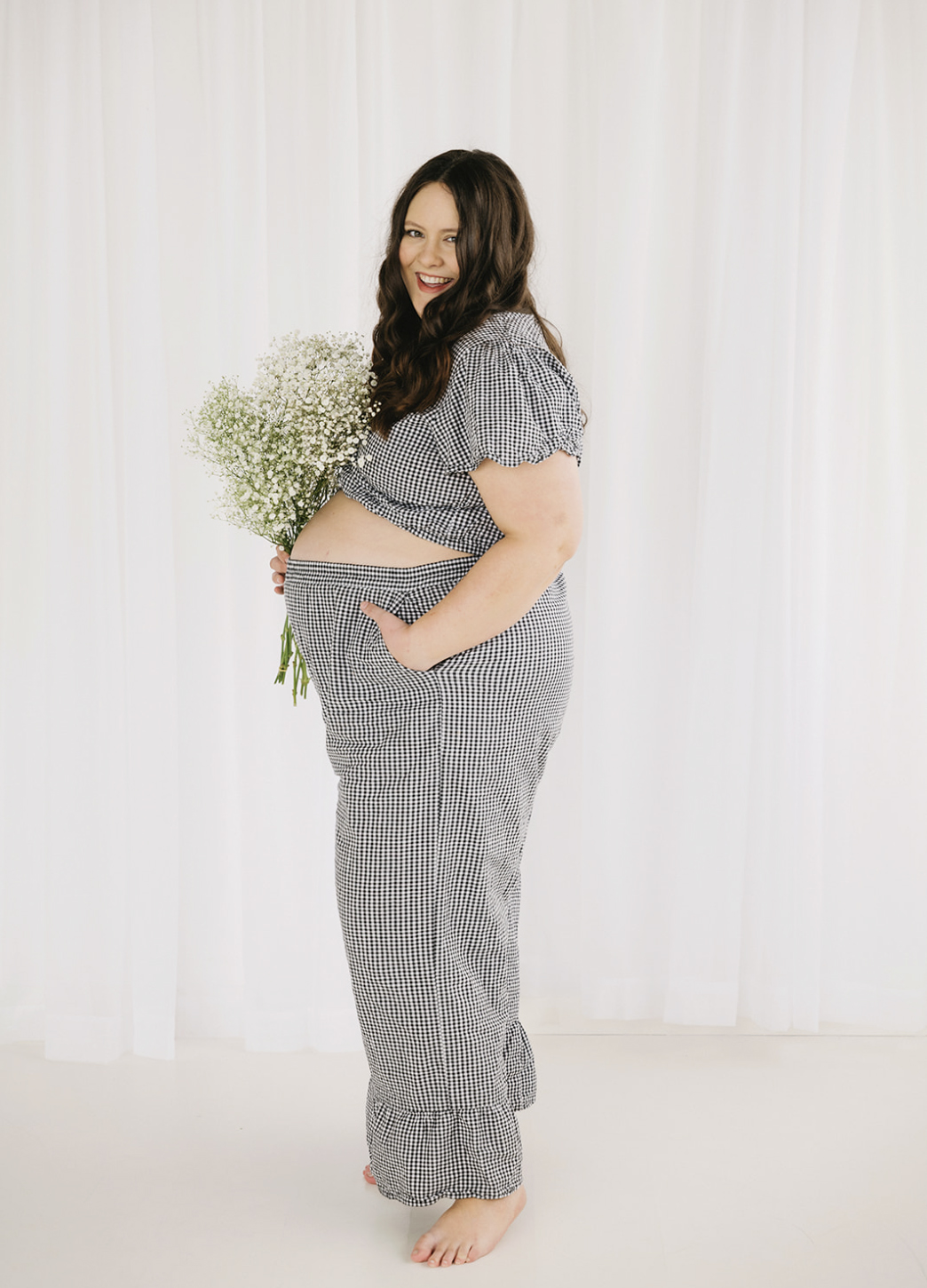 Olivia, Studio Photographer at Petite Portraits Fargo — smiling in the downtown studio.
