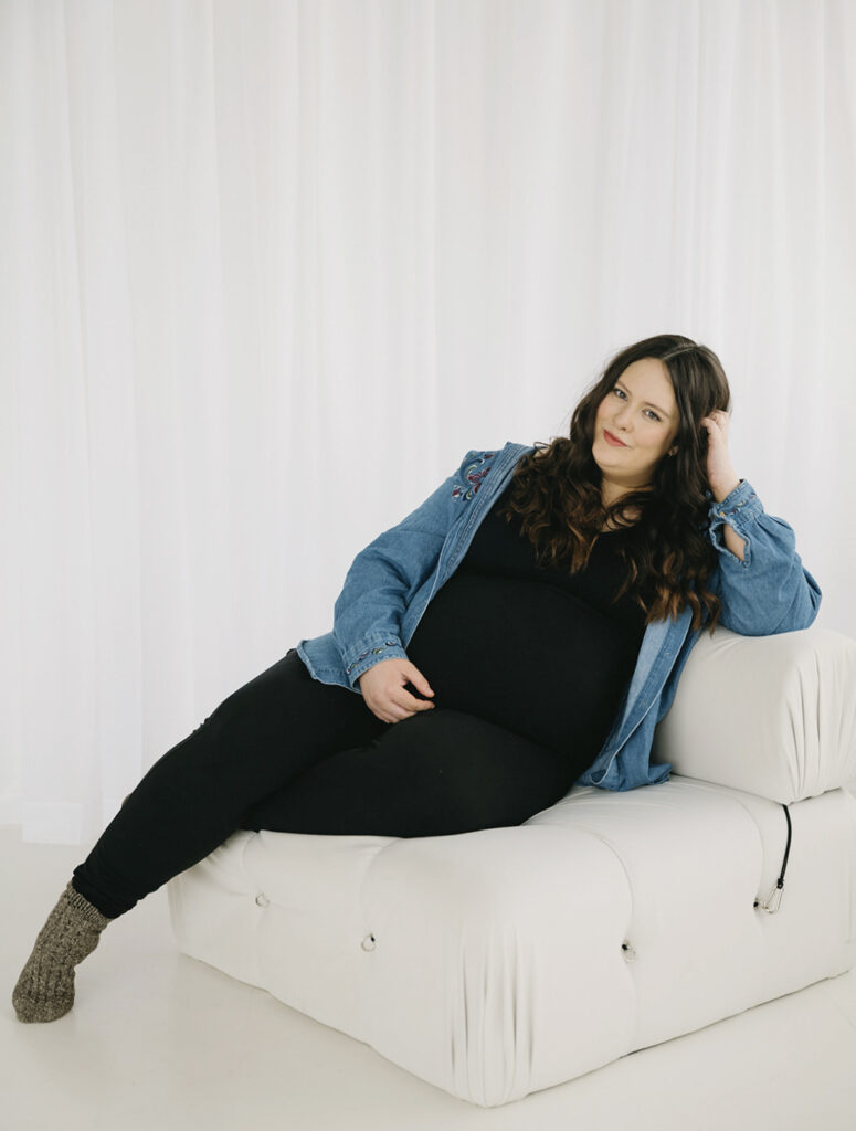 Olivia, Studio Photographer at Petite Portraits Fargo — smiling in the downtown studio.